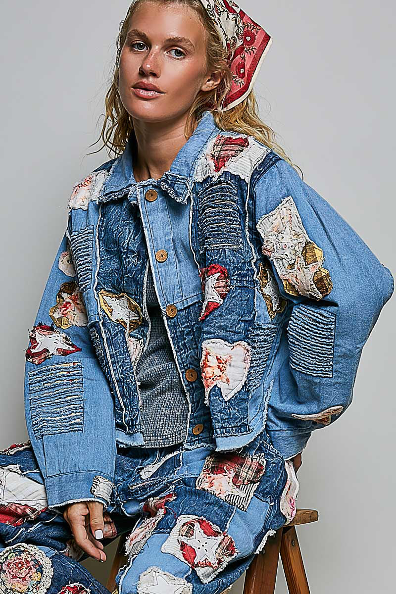 Relaxed-fit blue denim jacket with mixed patchwork fabric panels, appliqué details, collar, and button front