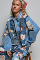 Relaxed-fit blue denim jacket with mixed patchwork fabric panels, appliqué details, collar, and button front