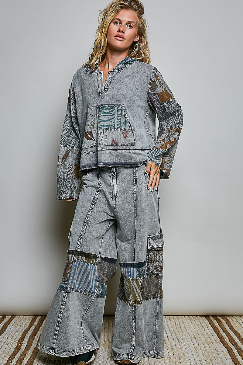Model wearing relaxed grey wide-leg pants with mixed printed patchwork panels