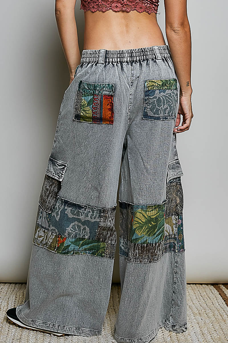 Grey wide-leg pants with mixed printed patchwork panels and utility pockets, back view
