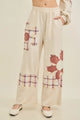 J.Her natural mineral washed flannel daisy pants front view with daisy appliqué detail