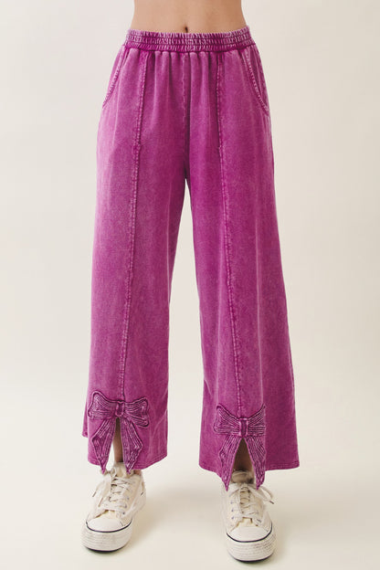 J.Her Mineral Washed Cute Bow Trim Slit Pants in magenta - Front view showing bow appliqué and slit hem detail