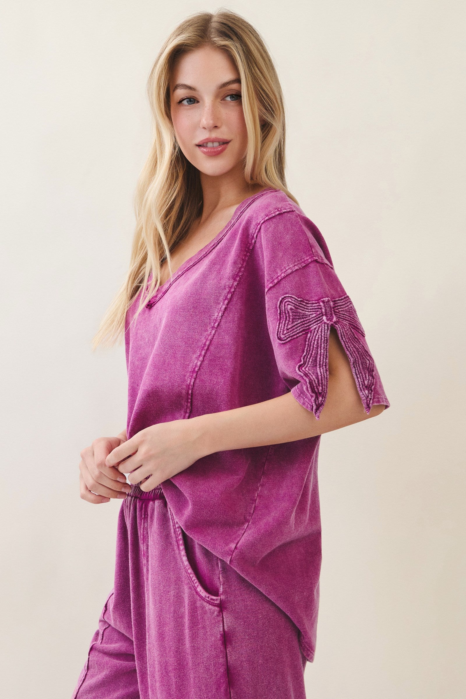 J.Her Mineral Washed Cute Bow Trim Slit Blouse Top in Magenta - Side view showing bow appliqué and kangaroo pocket