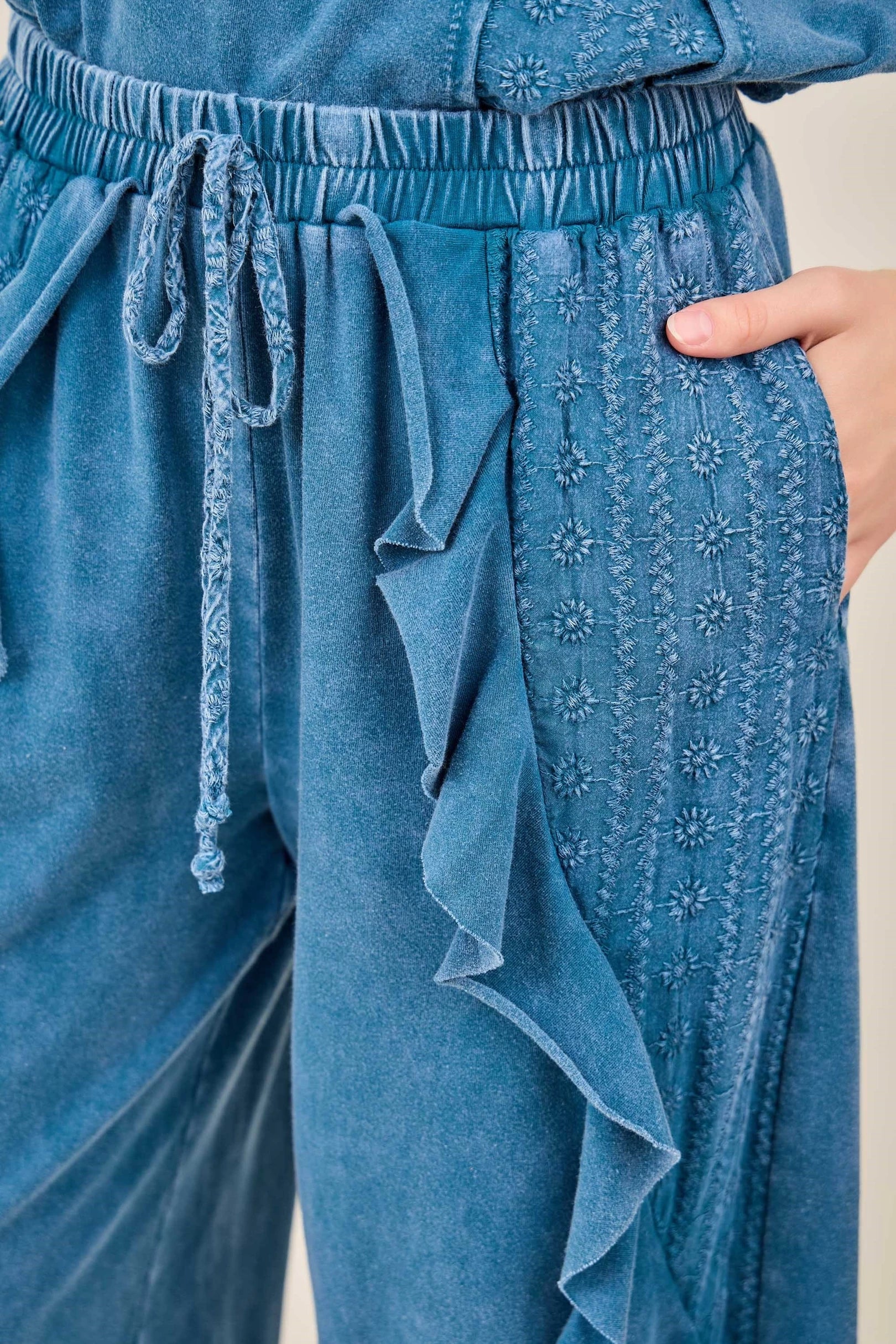 J.Her Mineral Washed Eyelet Ruffle Harem Pants in Slate Blue - Close up of eyelet embroidery and drawstring waist