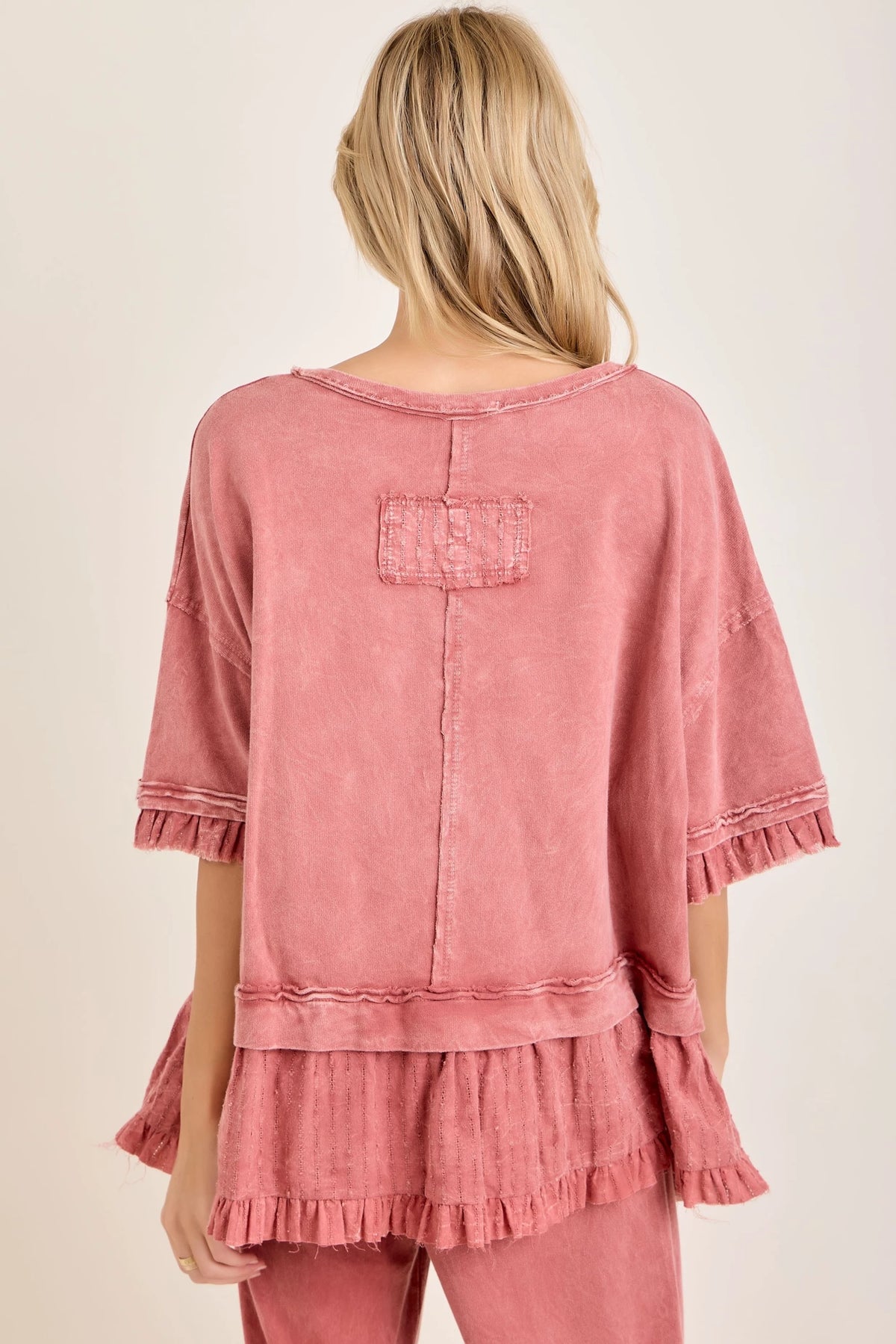 J.Her mineral washed bouclé eyelet ruffle top back view showing back patch pocket and ruffle hem