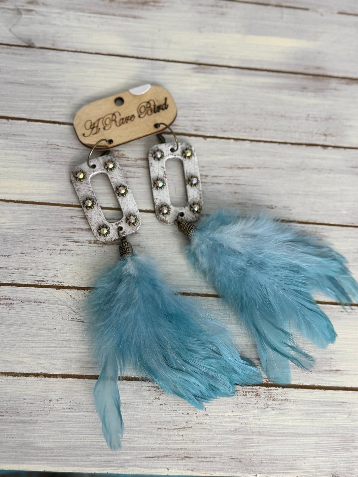 A Rare Bird White leather Blue feather earrings