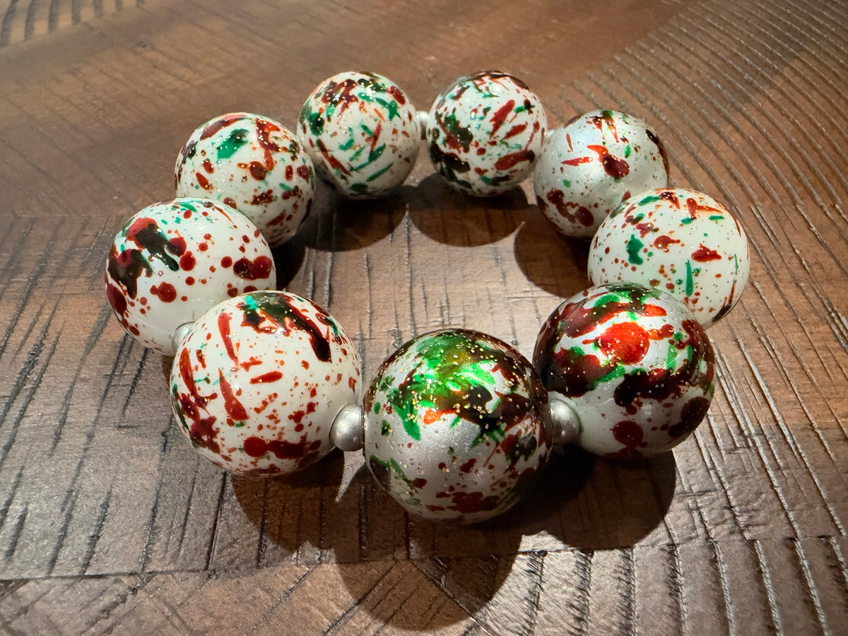 Alice holiday confetti stretch bracelet with large white beads, red and green splashes, and silver-tone spacers