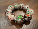 Alice holiday confetti stretch bracelet with large white beads, red and green splashes, and silver-tone spacers