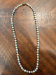 Alice Opal Glow necklace with alternating white opal-look and iridescent round stones in gold-tone settings, clasp at top