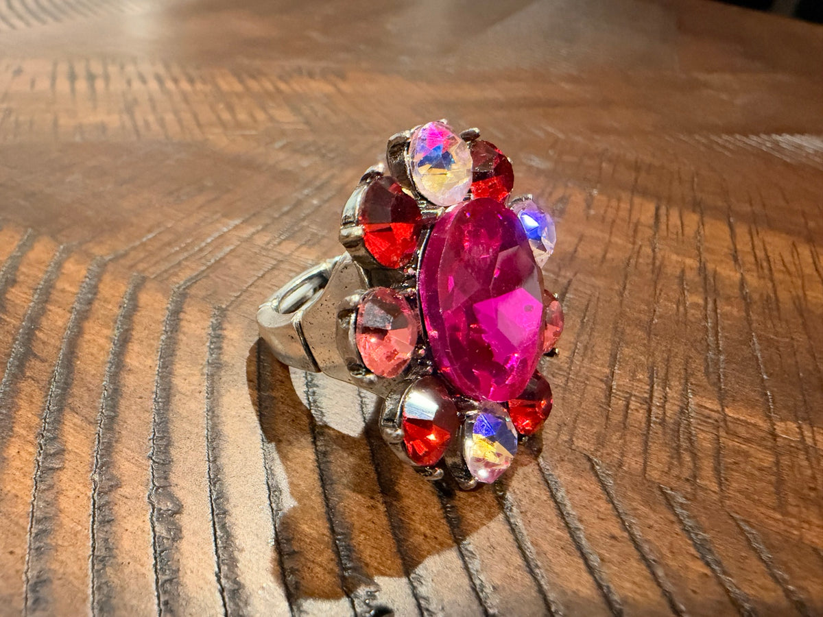 Pink oval flower statement ring with red, blush and iridescent accents — side view