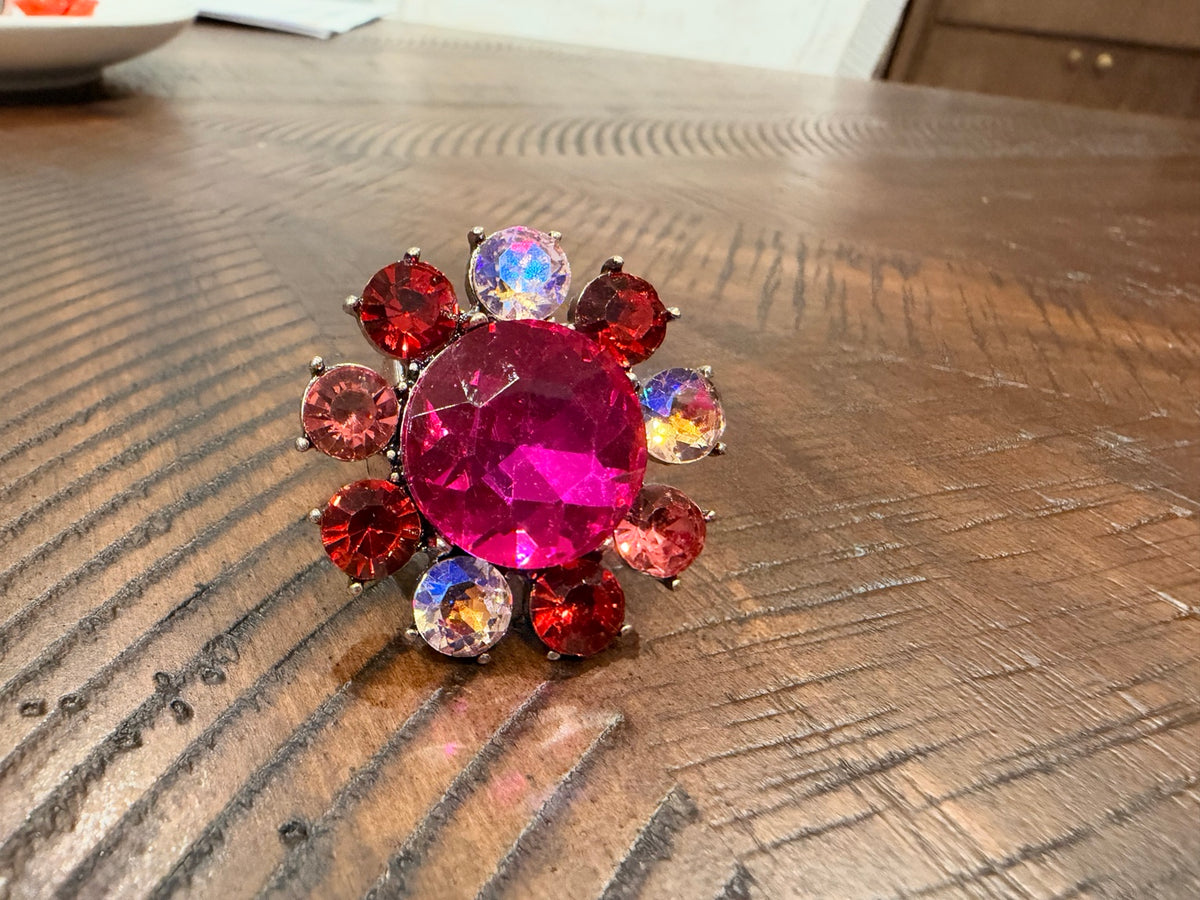 Pink oval flower statement ring with red, blush and iridescent accents — front view