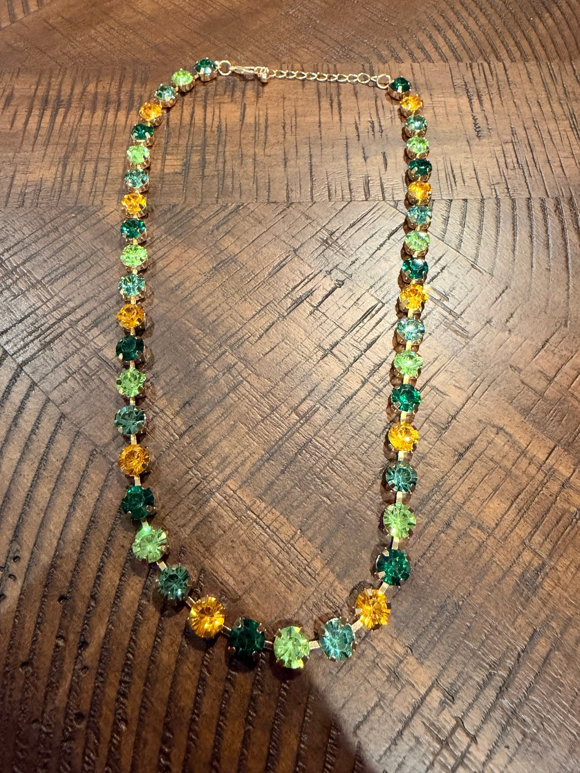 Green and golden yellow round crystal necklace in gold-tone settings