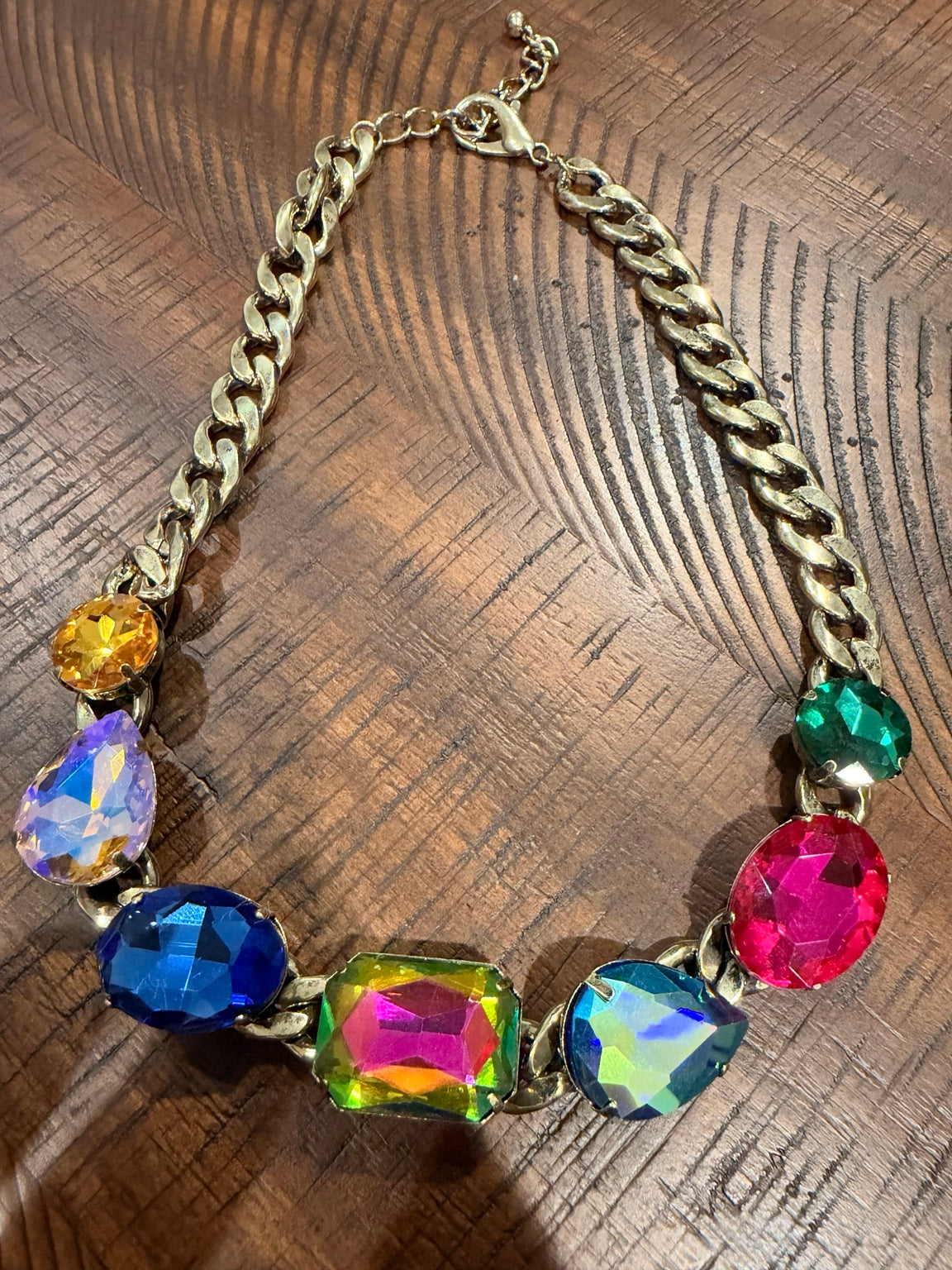 Upright gold-tone Fiesta curb chain necklace with seven colorful mixed-shape stones
