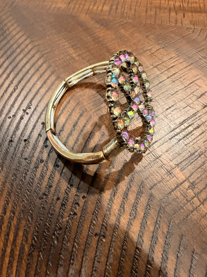Side view of gold-tone peace sign bracelet band