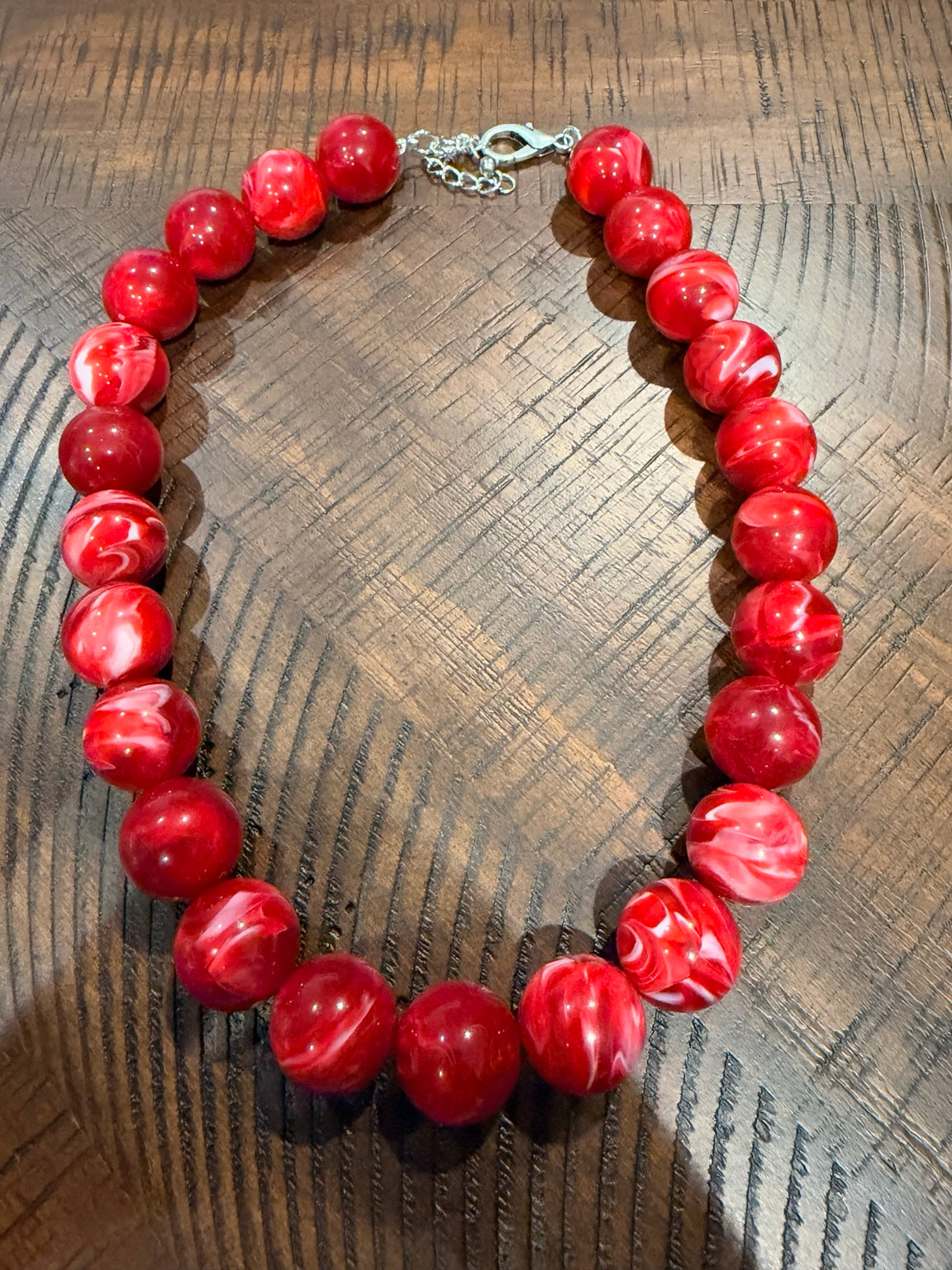 Cherry red round bead necklace with pale swirls and silver-tone clasp