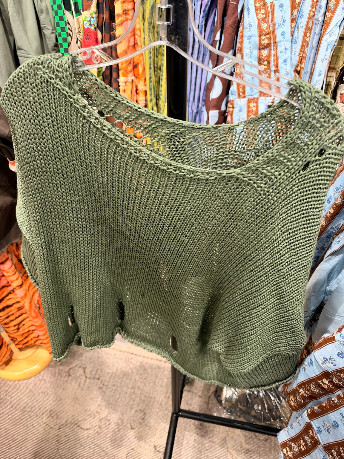 Olive open knit V-neck sweater with distressed hem details