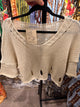 Cream open knit V-neck sweater with distressed hem details