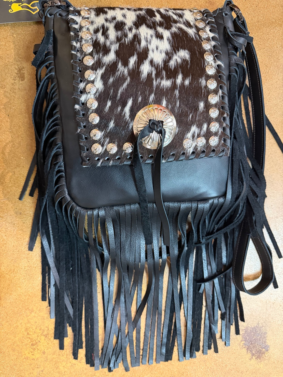 Kurtman Midnight Maverick fringe bag with mottled black and white flap, silver-tone conchos and long black fringe