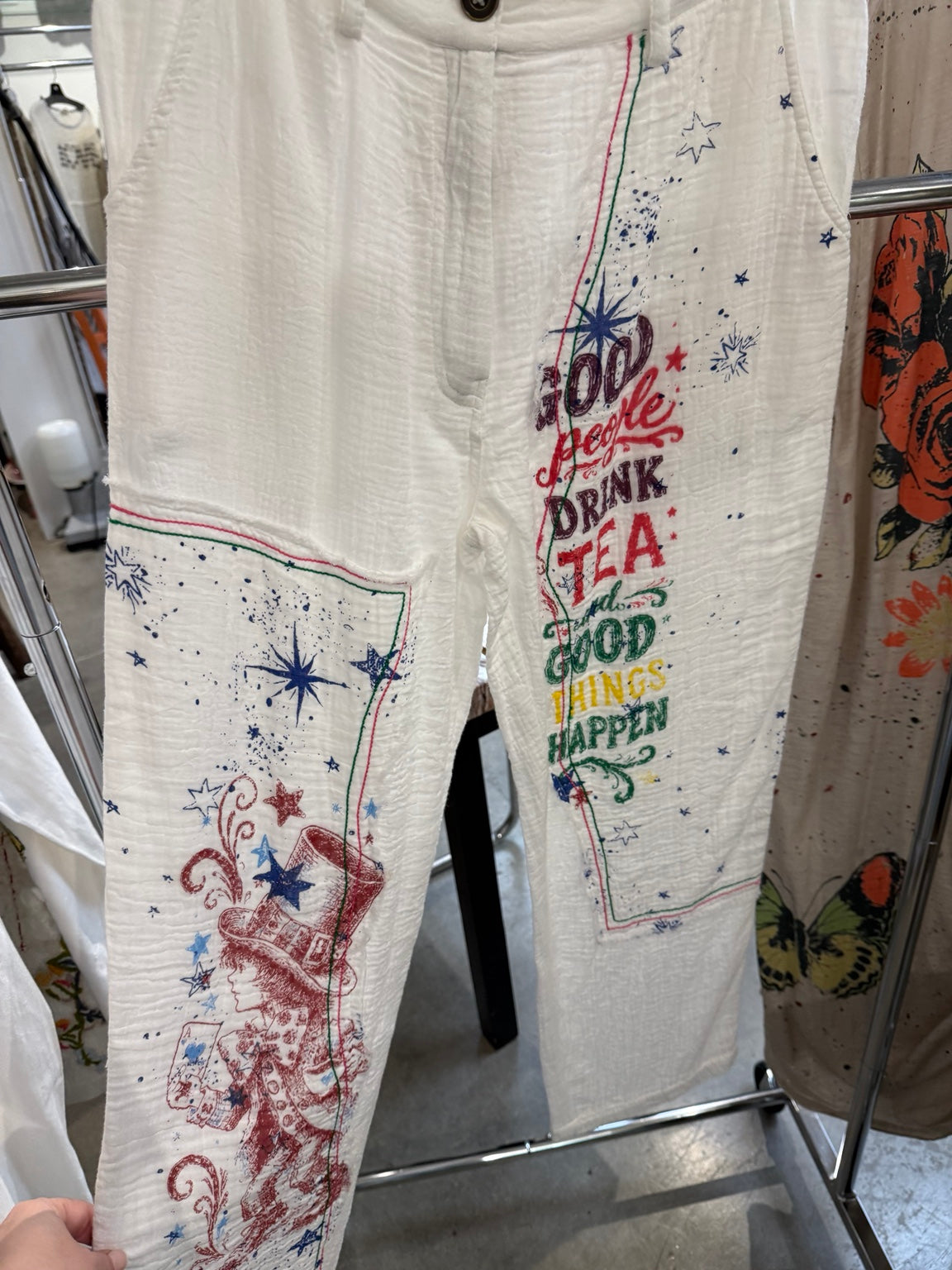 Paper Lace PL-G721P white pants with colorful tea party graphics, stars, and contrast stitching