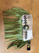 Kurtman patterned clutch with olive green fringe, dark studs and turquoise-colored concho