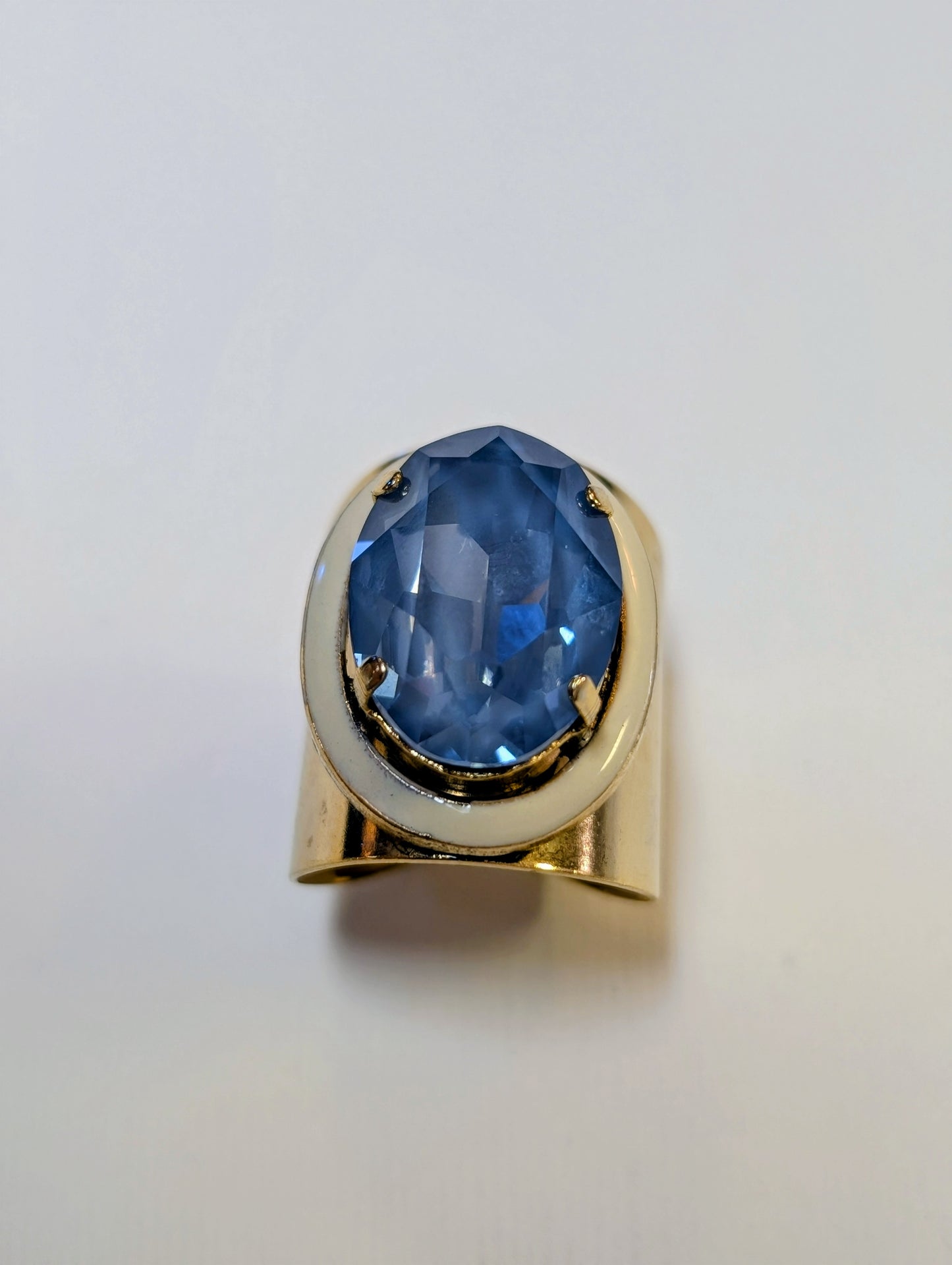 TOVA Jaccie Ring - oversized sapphire blue oval crystal on wide gold tone cuff band with ivory enamel accent