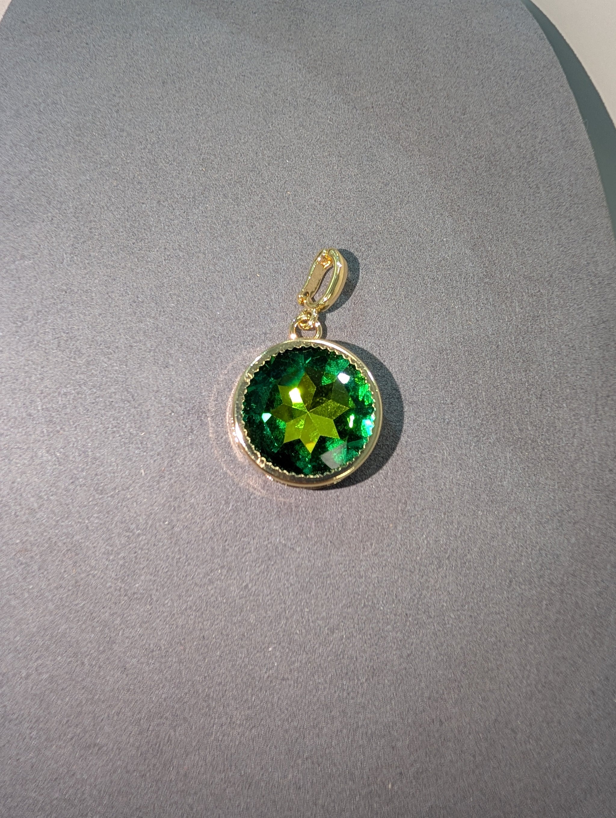 Wafa Round Crystal Charm in Emerald Green - large faceted round emerald green crystal in gold milgrain bezel setting with gold bail