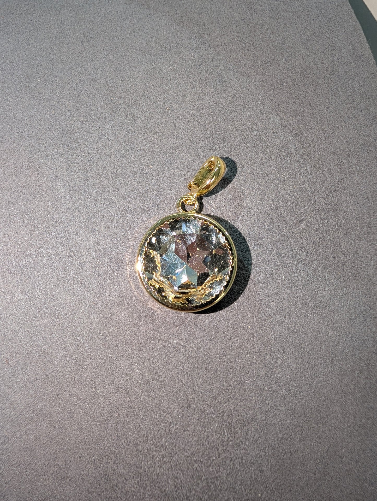 Wafa Round Crystal Charm in Clear Aurora - large faceted round clear aurora crystal in gold milgrain bezel setting with gold bail