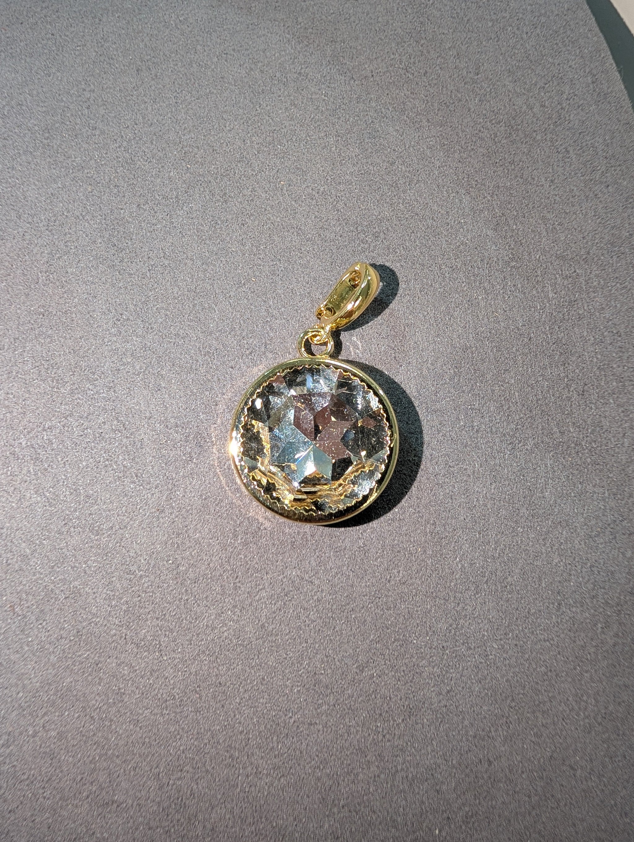 Wafa Round Crystal Charm in Clear Aurora - large faceted round clear aurora crystal in gold milgrain bezel setting with gold bail