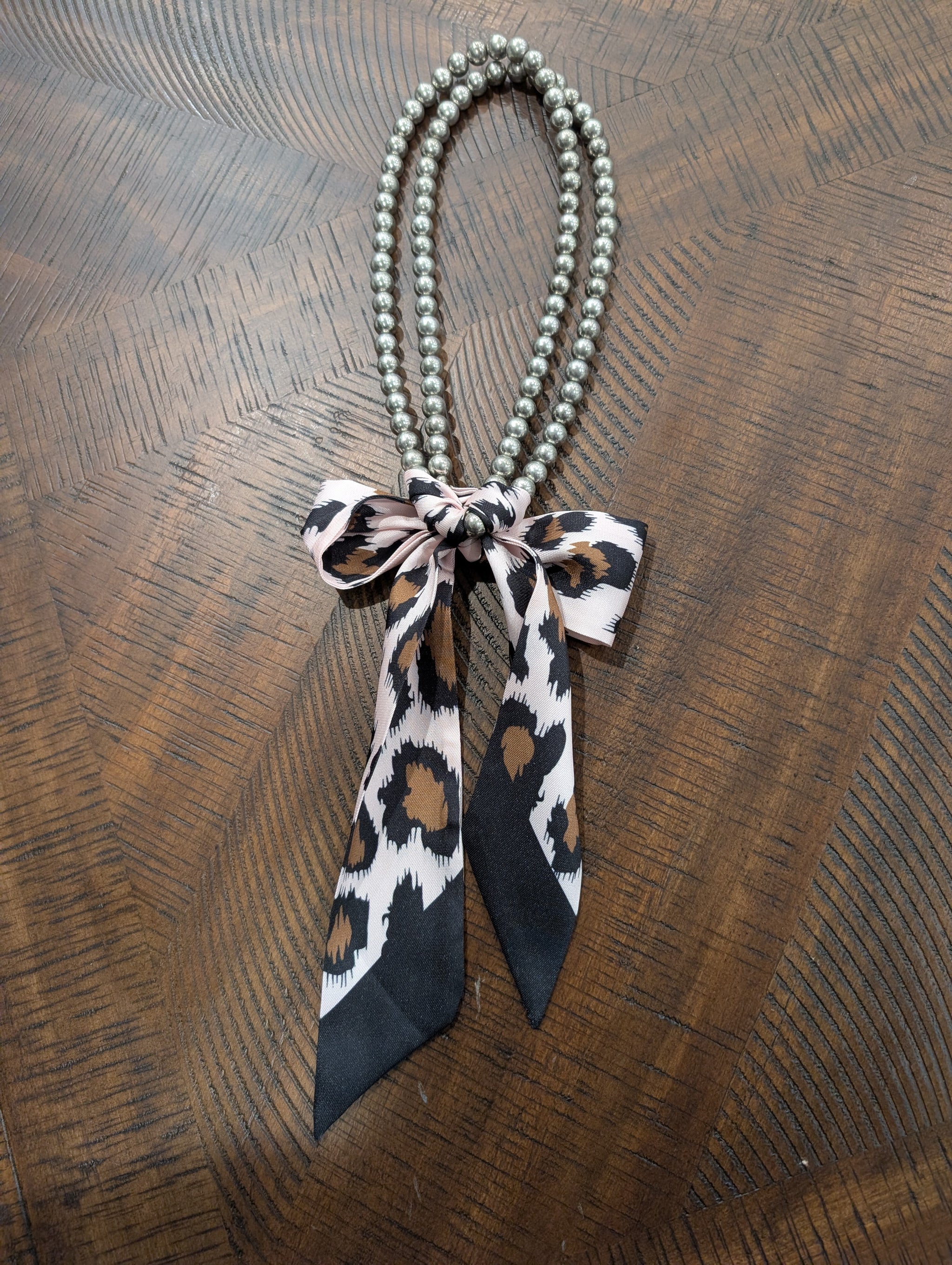 A Rare Bird Twilly Pearl Scarf Necklace in leopard print