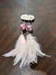 A Rare Bird Pink Glitter Bead Feather Earrings on branded wooden card