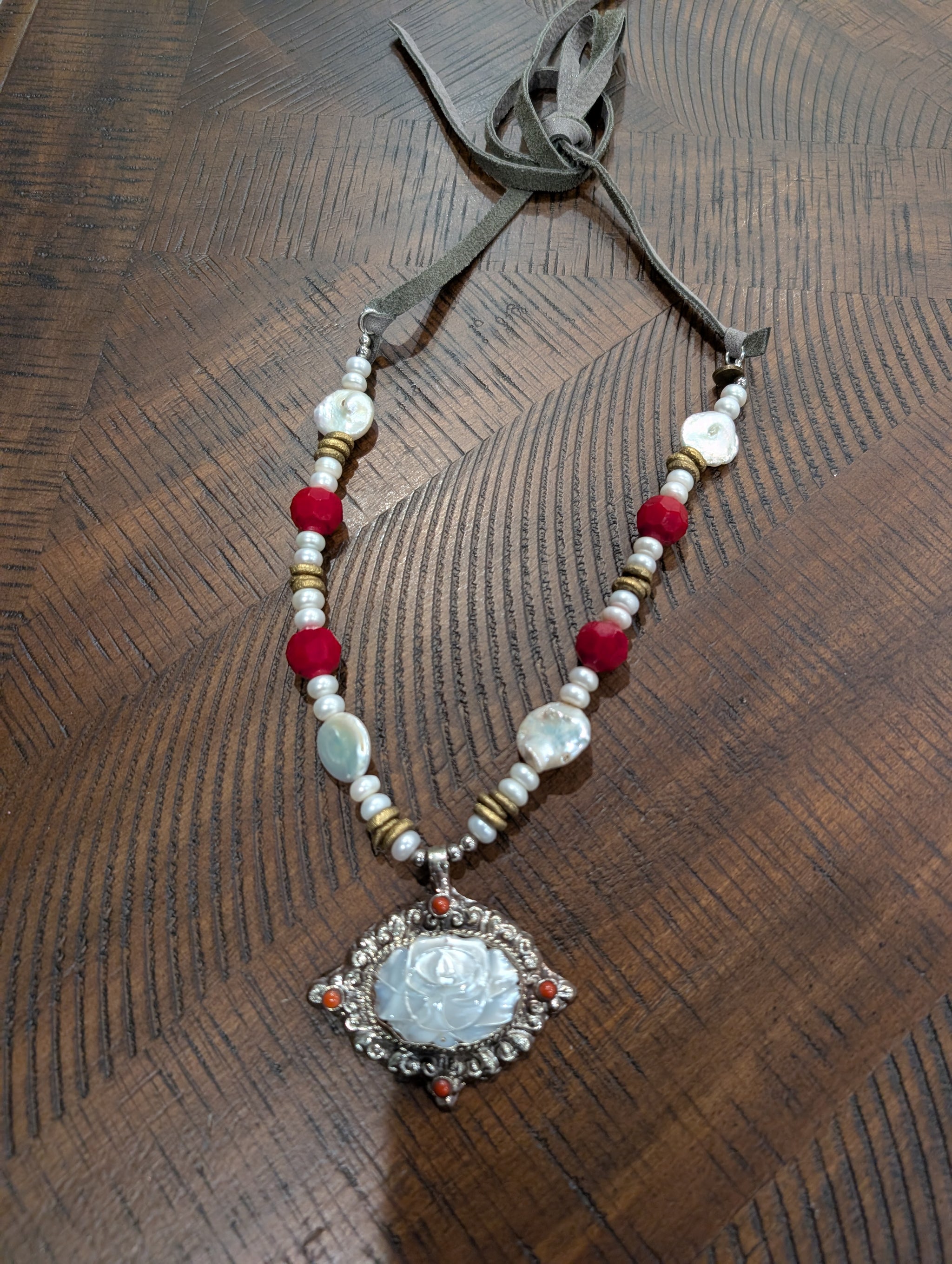 A Rare Bird Pearl Rose Carved Mother of Pearl Pendant Necklace with suede tie closure