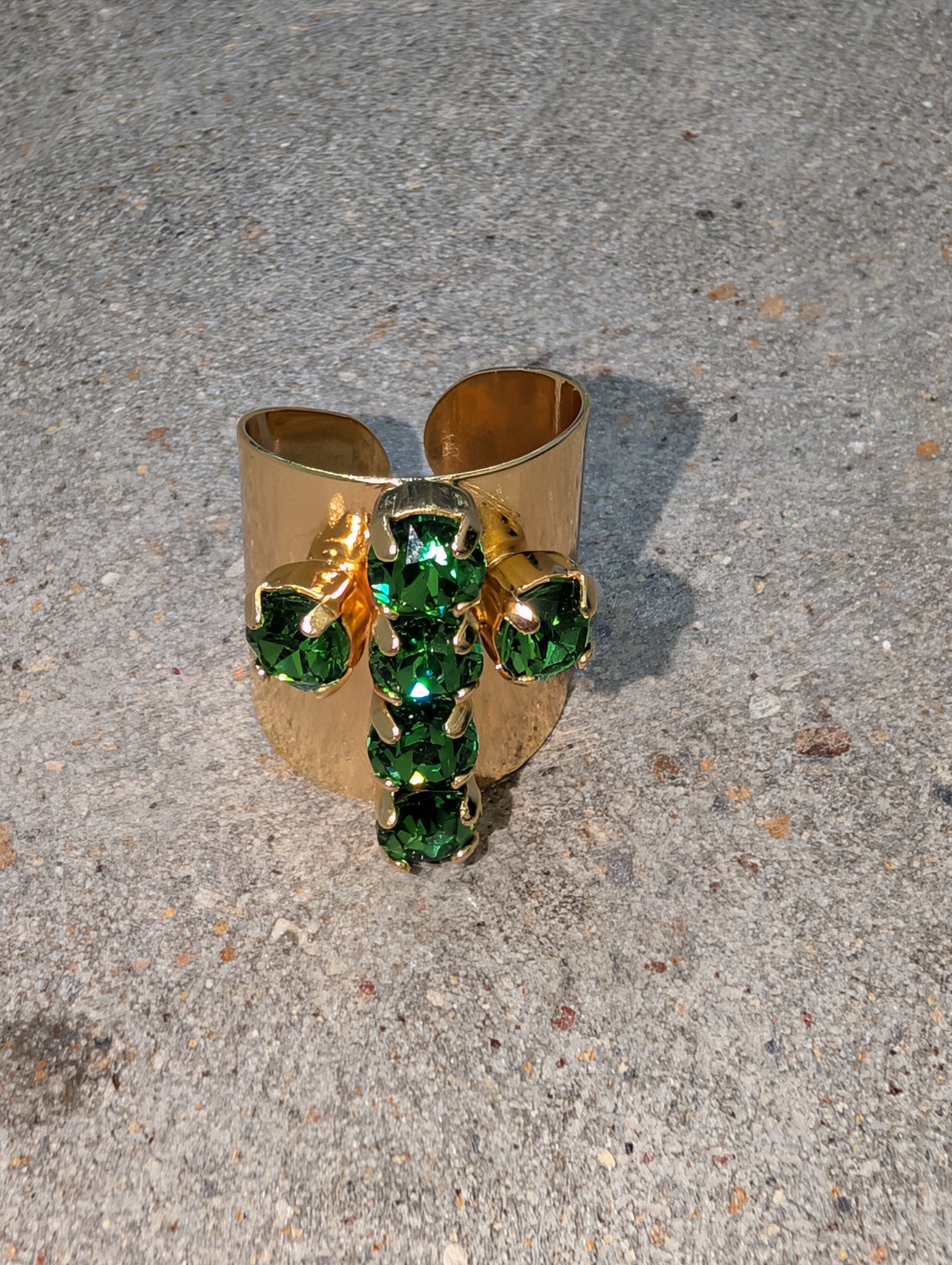 Pre Order WaFa Crystal Cross Wide Gold Cuff Ring — emerald green: vivid emerald green rhinestone cross motif with round and cushion-cut stones on wide hammered gold open cuff ring band