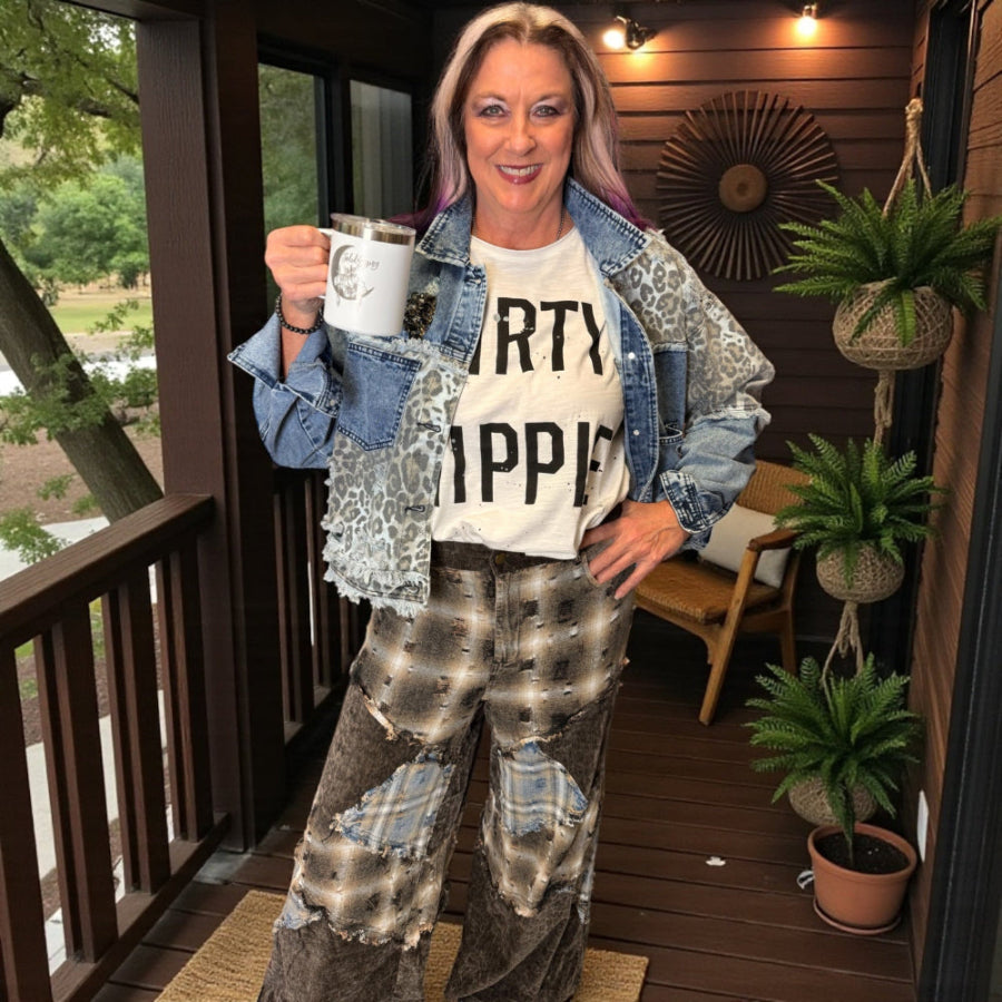 Woman holding a mug on a wooden deck with plants and a chair in the background