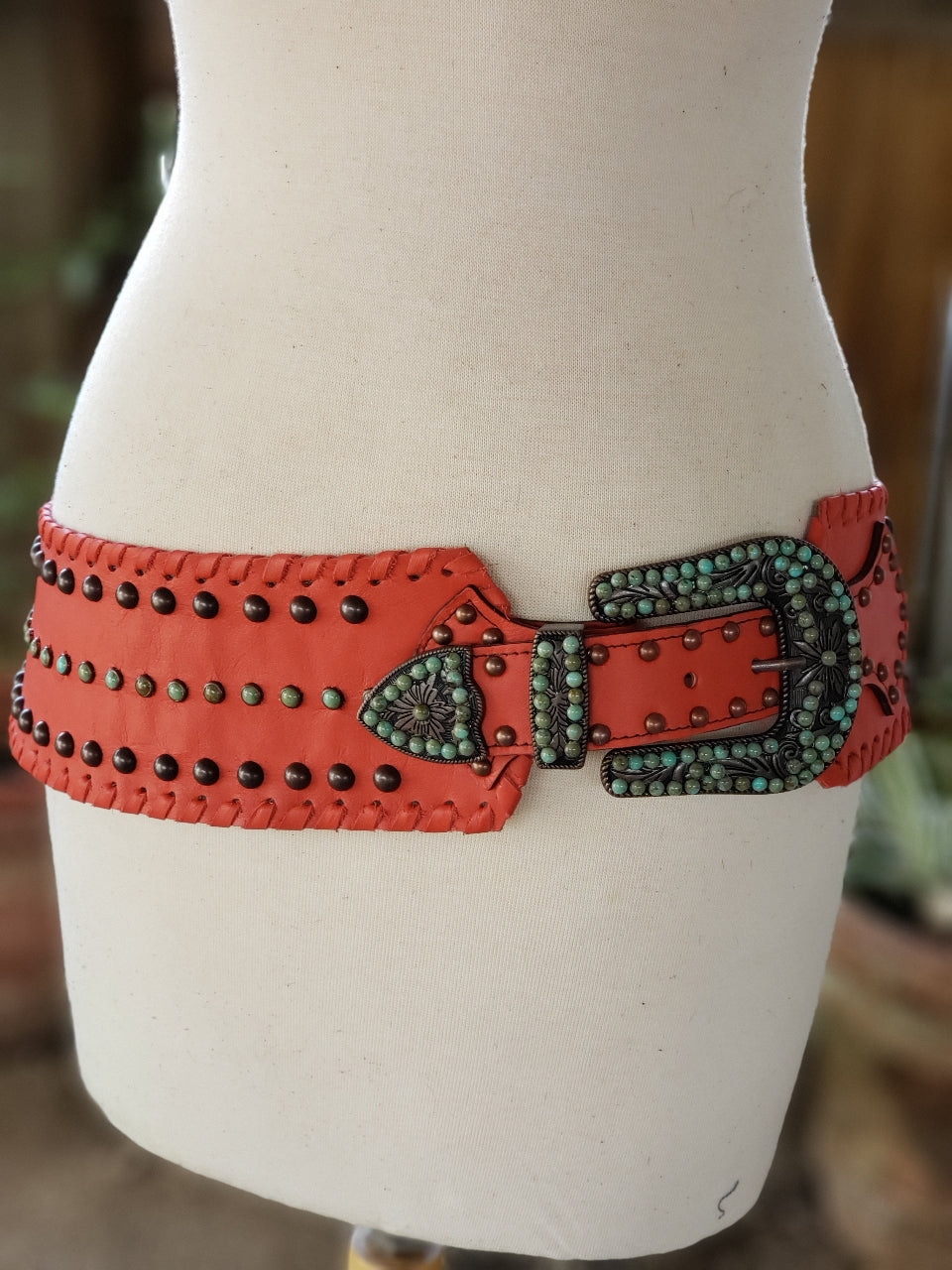 Kurtman Desert Fire coral statement belt with dark studs, turquoise-colored accents and ornate Western buckle