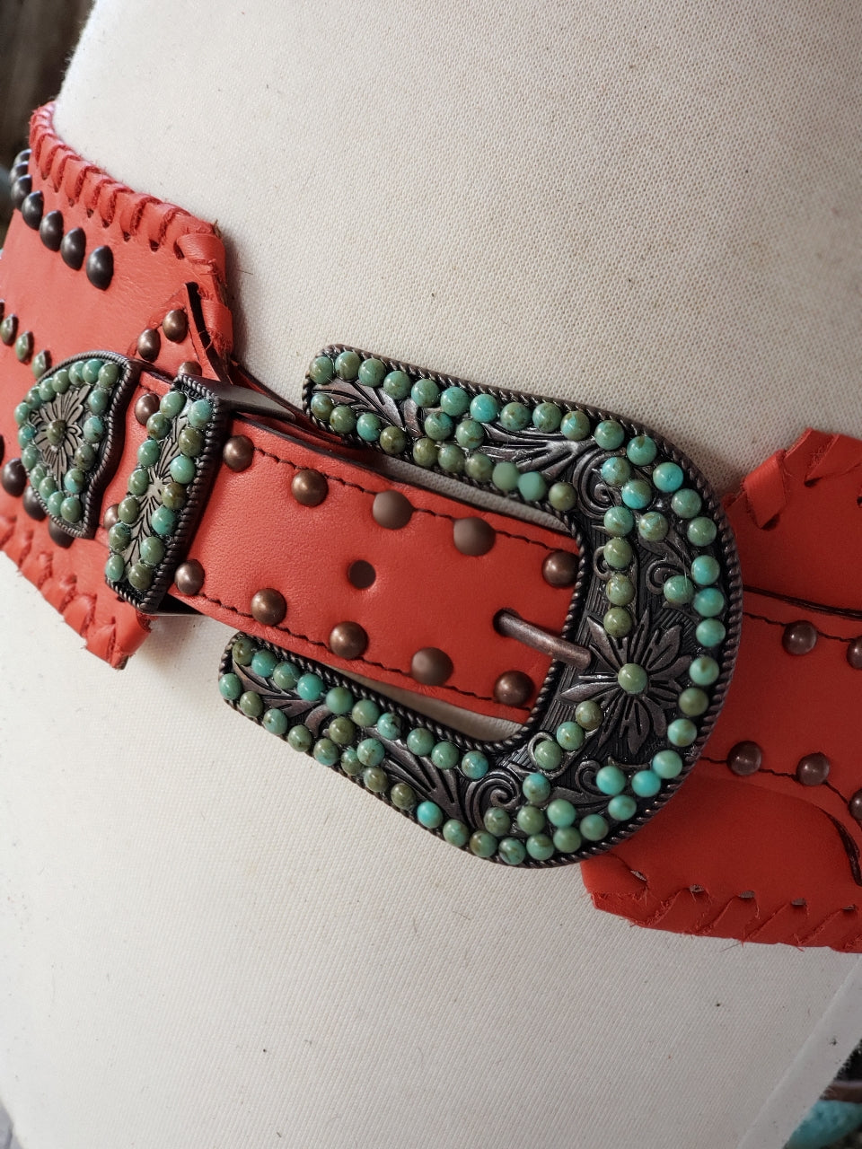 Kurtman Desert Fire coral statement belt with dark studs, turquoise-colored accents and ornate Western buckle