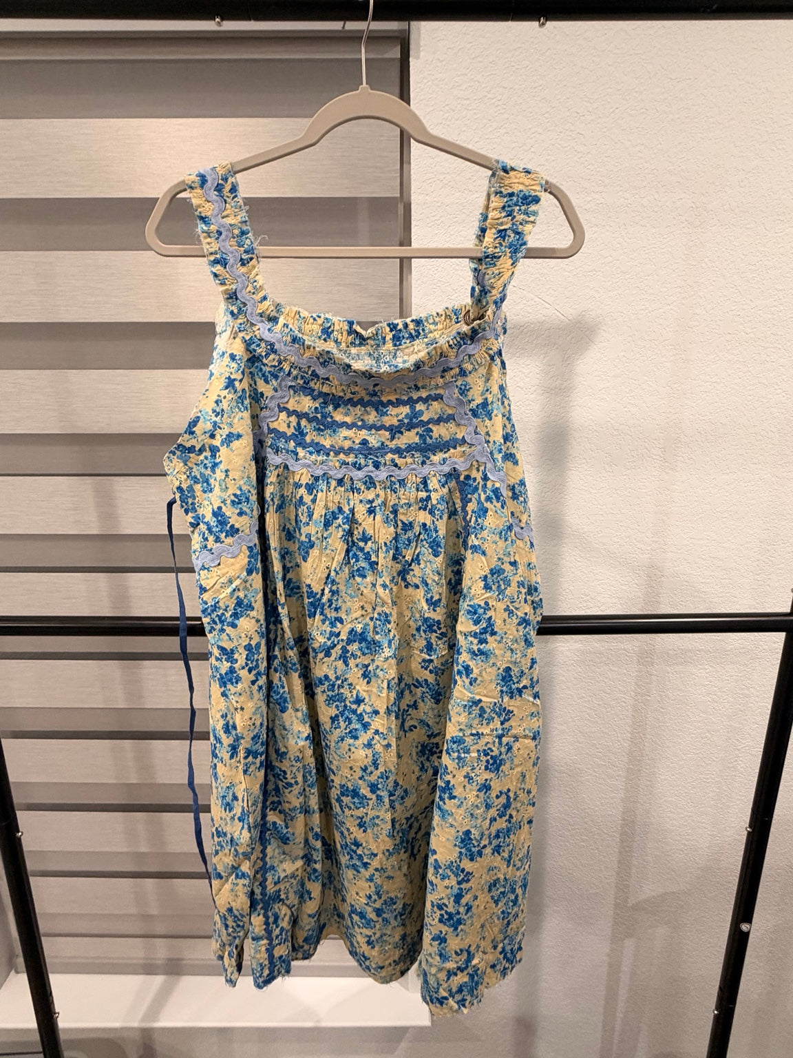A Rare Bird cream and blue floral eyelet dress with blue ricrac trim and wide straps, back view