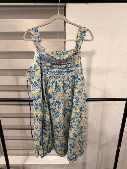 A Rare Bird cream and blue floral eyelet dress with blue ricrac trim and wide straps, back view