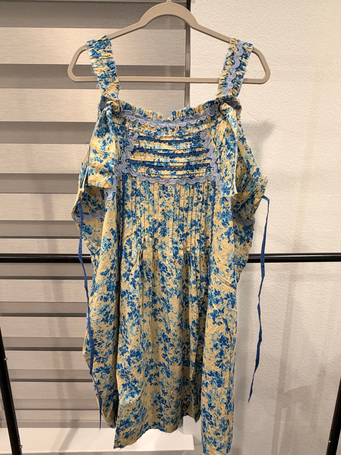 A Rare Bird cream and blue floral eyelet dress with blue ricrac trim and wide straps, front view