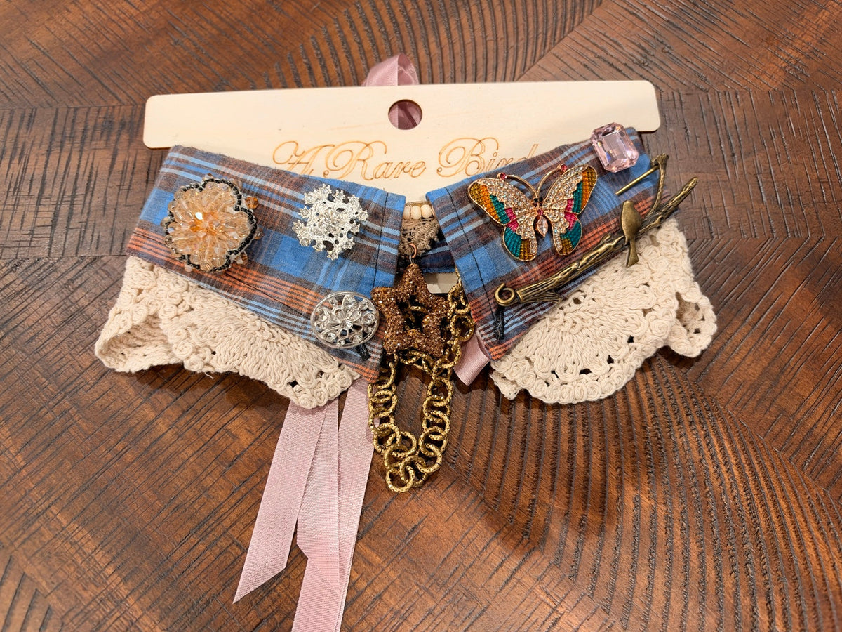 Blue and rust plaid with a colorful butterfly, bird-on-branch ornament, sparkling flowers, and a star pendant.