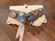 Blue and rust plaid with a colorful butterfly, bird-on-branch ornament, sparkling flowers, and a star pendant.