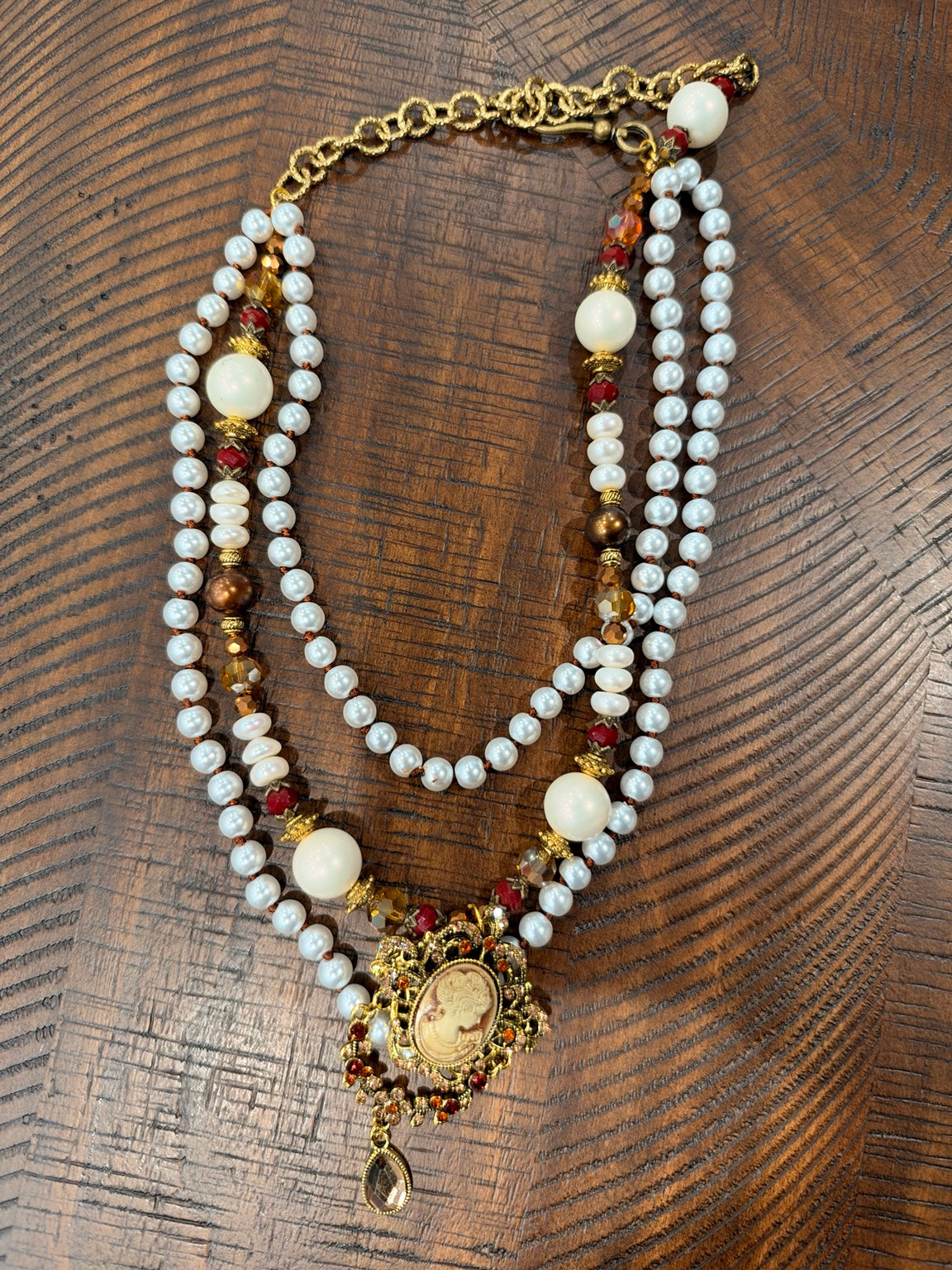 A Rare Bird layered pearl-look bead necklace with ornate gold-tone cameo, amber and red accents