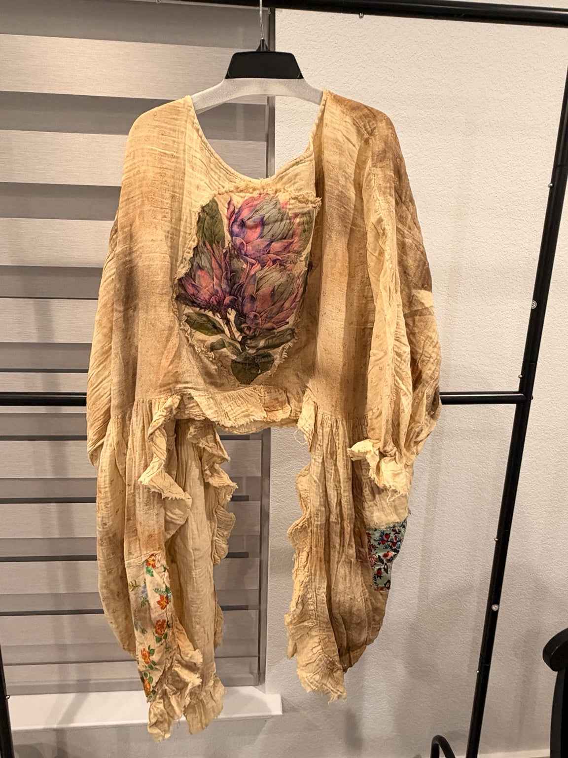 A Rare Bird Golden Songbird Patchwork Ruffle Top in golden beige with floral patches and cascading ruffles, back