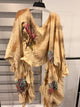 A Rare Bird Golden Songbird Patchwork Ruffle Top in golden beige with floral patches and cascading ruffles, front with hummingbird detail