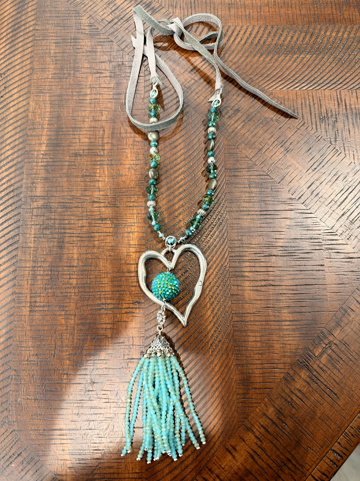 A Rare Bird Heartstrings necklace with silver-tone open heart and turquoise beaded tassel