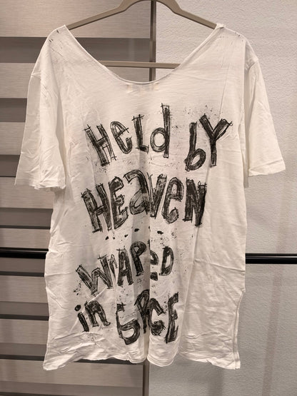 Back of A Rare Bird white graphic tee reading Held by Heaven Wrapped in Grace