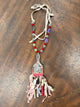 A Rare Bird red paintbrush pendant necklace with sparkling flower, mixed beads and ribbon fringe