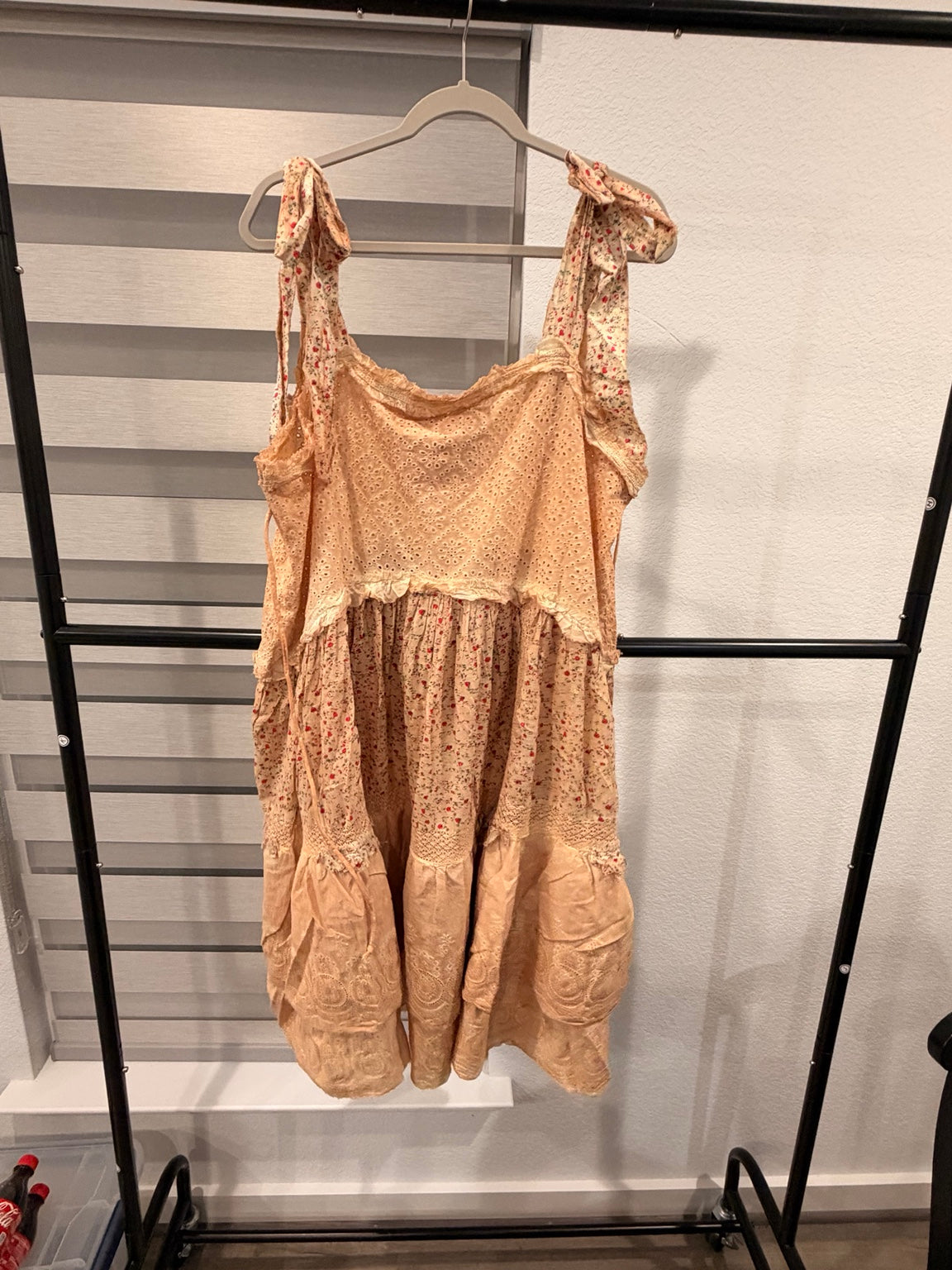 A Rare Bird peach floral eyelet dress with tie shoulders, tiered skirt, and star-print front pockets, back view