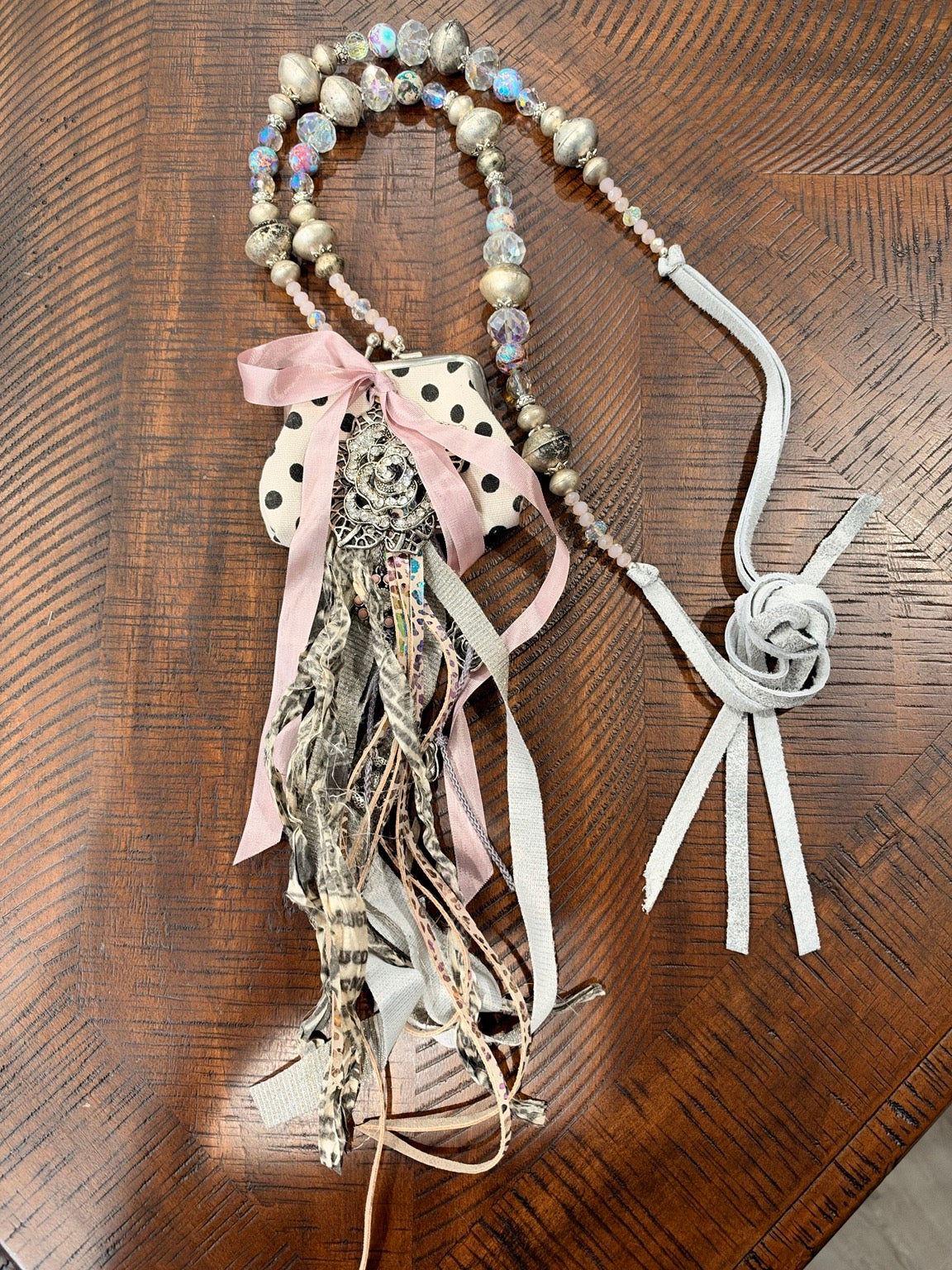 A Rare Bird cream and black polka dot coin purse necklace with rose accent and ribbon fringe