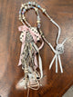A Rare Bird cream and black polka dot coin purse necklace with rose accent and ribbon fringe