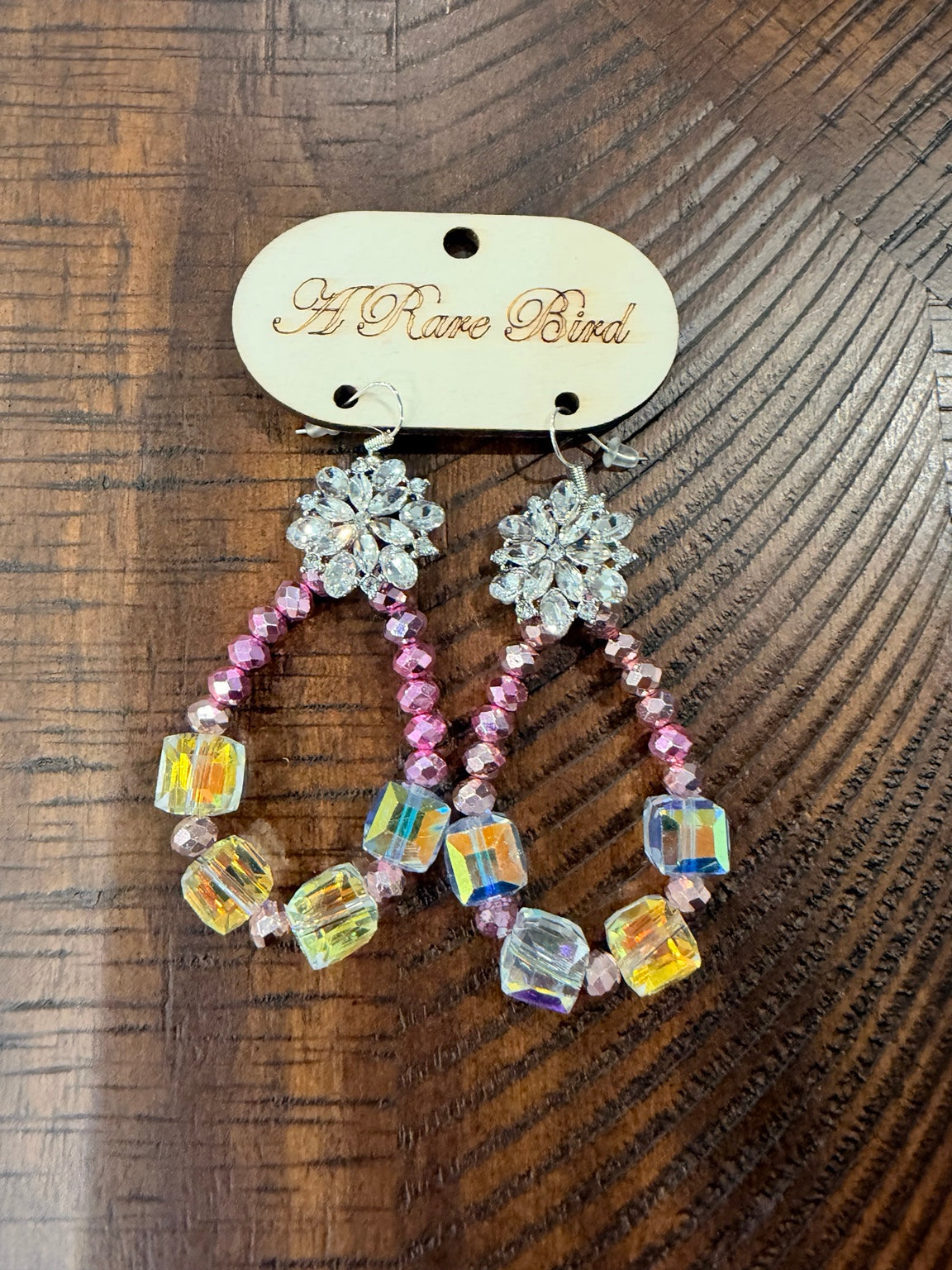 A Rare Bird pink beaded teardrop earrings with iridescent cube beads and sparkling floral tops